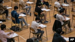 FILE - Students sit for the Diploma of Secondary Education (DSE) exams April 26, 2021, in Hong Kong.