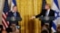 FILE - U.S. President Donald Trump, right, reaches out to Israeli Prime Minister Benjamin Netanyahu during a joint news conference at the White House in Washington, Feb. 15, 2017. 