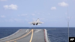 FILE - In this photo released by China's Xinhua News Agency, a J-15 Chinese fighter jet takes off from the Shandong aircraft carrier, April 9, 2023.