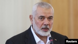  FILE PHOTO: Palestinian group Hamas' top leader, Ismail Haniyeh and Iran's Foreign Minister Hossein Amir Abdollahian attend a press conference in Tehran