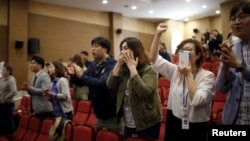 A French fan is all geared up for the game in national colors, in Paris, France, July 15, 2018. (L. Bryant/VOA)