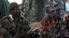FILE - The leader of the Lord's Resistance Army, Joseph Kony, left, and his deputy, Vincent Otti, are seen sitting inside a tent in Ri-Kwamba, southern Sudan, Nov. 12, 2006.