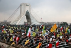Iranians attend a ceremony celebrating the 40th anniversary of the Islamic Revolution, at the Azadi, or Freedom Tower, in Tehran, Iran, Monday, Feb. 11, 2019.