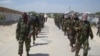 FILE - Members of Somalia's al- Shabab militant group patrol on foot on the outskirts of Mogadishu, Somalia, March 5, 2012. The U.S. military said Wednesday it has resumed airstrikes against the extremist group.