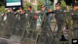 Riot police stand guard at a blocked street outside the Supreme Court in Phnom Penh, Cambodia, Nov. 16, 2017.