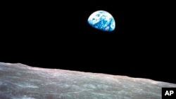 FILE - This Dec. 24, 1968, photo made available by NASA shows the Earth behind the surface of the moon during the Apollo 8 mission.