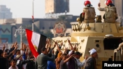 Supporters of Egypt's President Abdel-Fattah el-Sissi cheer at soldiers during a demonstration against the Muslim Brotherhood and other Islamist groups at Tahrir Square in Cairo, Nov. 28, 2014. 
