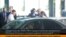 Image released by Russia24 TV channel, shows Russian lawyer Anatoly Kucherena, second right in the center, and National Security Agency leaker Edward Snowden, center back to a camera, Aug. 1, 2013.