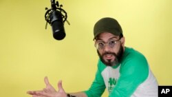 FILE - Alex Otaola speaks during an interview in Miami, Jan. 16, 2020. Otaola, a 40-year-old Cuban-born YouTube personality, has organized boycotts of Cuban figures that have led to de facto bans on their performing in South Florida.