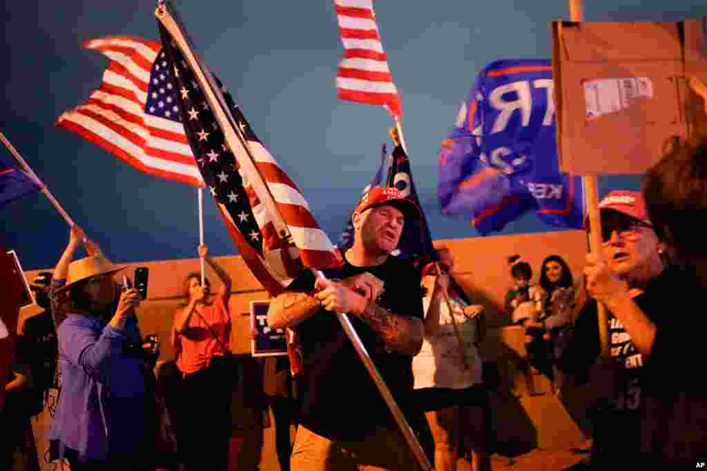 A supporter of President Donald Trump, center, engages with a supporter of Democratic presidential candidate former Vice President Joe Biden, off camera, during a protest in Las Vegas, Nevada, Nov. 6, 2020.