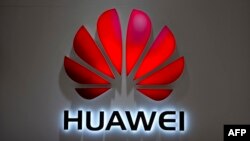 FILE - In this July 4, 2018, photo, the Huawei logo is seen at a Huawei store at a shopping mall in Beijing. 