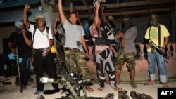 FILE - Abu Misry Mama (front L), spokesman of the Bangsamoro Islamic Freedom Fighters (BIFF) a splinter group of the Moro Islamic Liberation Front (MILF) that still wants independence, along with colleagues shout "Allah Akbar" (God is Great) after an interview with selected members of the media in Maguindanao, in southern island of Mindanao.
