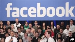 FILE - President Barack Obama, accompanied by Facebook CEO Mark Zuckerberg, speaks during a town hall at Facebook headquarters, Palo Alto, California, April 20, 2011.