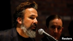 FILE - Manuel Oliver, father of Joaquin Oliver, one of 17 people killed in the 2018 shootings at Marjory Stoneman Douglas High School in Parkland, Fla., speaks at a press conference on the one-year anniversary of the attack, in New York, Feb. 14, 2019.