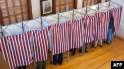 FILE - Voters cast their ballots at the Sutton town hall in the U.S. presidential election, Nov. 8, 2016 in Sutton, New Hampshire. Up to 39 U.S. states were targeted by cyberattacks in the 2016 U.S. election but state officials are yet to learn details collected on the attacks by the federal government.