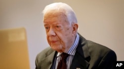 Former US President Jimmy Carter listens during a video interview with the Associated Press via a laptop at a hotel in London, Tuesday, Feb. 2, 2016. 