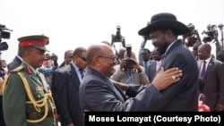 South Sudanese President Salva Kiir (r.) hugs his Sudanese counterpart Omar al Bashir on his arrival at Juba airport on Friday, April 12, 2013. The Sudanese president was visiting South Sudan for the first time since it split from Sudan in 2011.