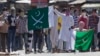Kashmiri protesters hold Pakistani flags, one with swords and the word "jihad" written on it, during a protest in Srinagar, India, July 8, 2016. Youths in the Indian part of Kashmir protested allegations that Islamic preacher Zakir Naik was involved in making hate speeches.