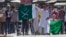 Kashmiri protesters hold Pakistani flags, one with swords and the word "jihad" written on it, during a protest in Srinagar, India, July 8, 2016. Youths in the Indian part of Kashmir protested allegations that Islamic preacher Zakir Naik was involved in making hate speeches.