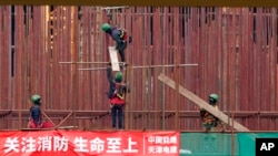 FILE - Workers are seen at the construction site of the first Chinese car tire factory in Europe near the northern Serbian town of Zrenjanin, 50 kilometers north of Belgrade, Serbia, Nov. 18, 2021. 