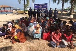 Rohingya refugees wait after their boat capsized near the Saint Martin's island in the Bay of Bengal, in Teknaf, near Cox's Bazar, Bangladesh, February 11, 2020. REUTERS/Stringer NO RESALES. NO ARCHIVES