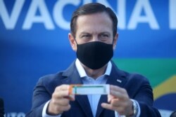 Brazil's Sao Paulo state Governor, Joao Doria, holds a box of China's Sinovac COVID-19 vaccine at Sao Paulo International Airport in Guarulhos, near Sao Paulo, Brazil, March 4, 2021.