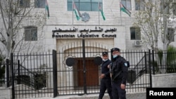 Palestinian policemen guard outside the Palestinian legislative council in Ramallah, in the Israeli-occupied West Bank, Jan. 16, 2021. 