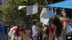 Demonstrators prepare banners at the town hall square in Valencia, Spain, May 21, 2011. Spaniards take their protests over sky high unemployment and austerity into a seventh day across the country.