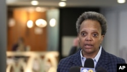 FILE - In this March 15, 2020 file photo, Chicago Mayor Lori Lightfoot speaks to reporters at O'Hare International Airport in Chicago.
