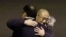FILE - Kenneth Bae, center, who had been held in North Korea since 2012, is hugged after arriving at Joint Base Lewis-McChord, Washington, Nov. 8, 2014.