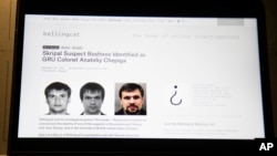 The website of the British investigative group Bellingcat showing alleged photos of Col. Anatoliy Chepiga is seen on a computer screen in Moscow, Russia, Sept. 27, 2018.