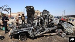 Iraqi security forces inspect the site of a car bomb attack in Basra, 340 miles (550 kilometers) southeast of Baghdad, Iraq, Sept. 15, 2013.