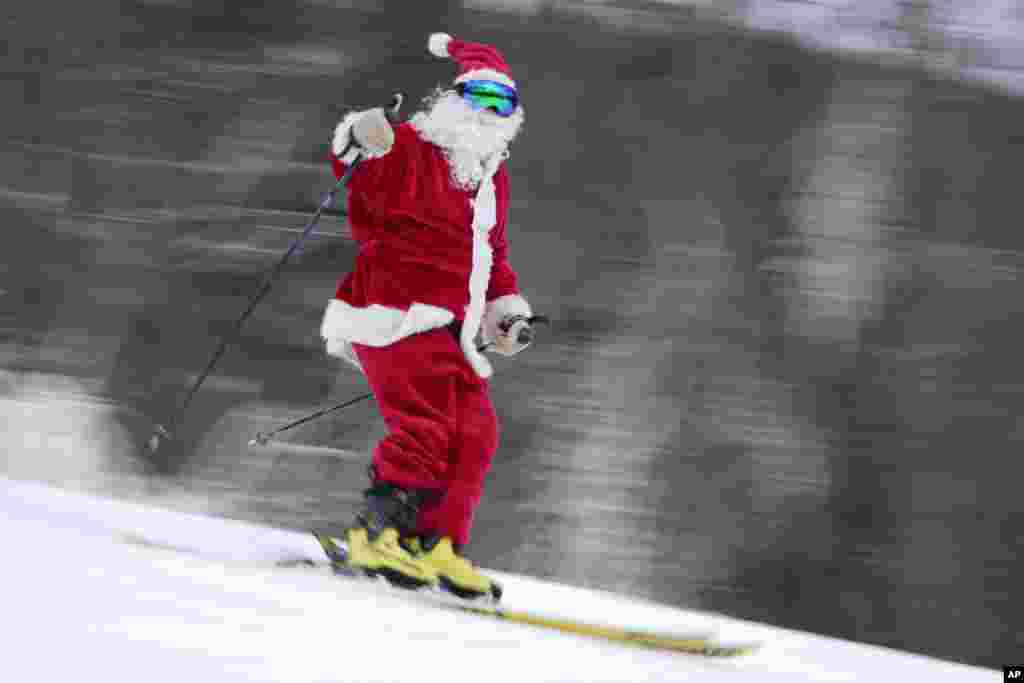 A skier dressed as Santa Claus skis for charity at the Sunday River Ski Resort, Dec. 11, 2022, in Newry, Maine.&nbsp;