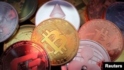 FILE - Representations of cryptocurrencies are seen in this illustration picture taken June 2, 2021. 