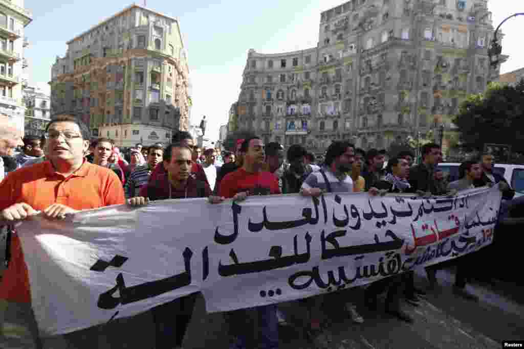 Anti-government protesters shout slogans against a new law in Egypt that restricts demonstrations, in downtown Cairo, Nov. 26, 2013.