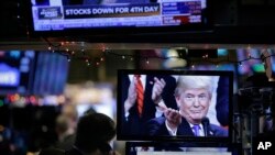 FILE- A picture of President Donald Trump is displayed on a computer on the floor of the New York Stock Exchange in New York, Dec. 24, 2018. 