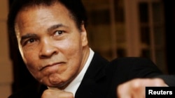 FILE - U.S. boxing great Muhammad Ali poses during the Crystal Award ceremony at the World Economic Forum (WEF) in Davos, Switzerland, January 2006. 