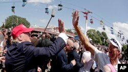 FILE - Donald Trump greets the crowd at the Iowa State Fair in Des Moines, Aug. 15, 2015, when he was a candidate for the Republican presidential nomination. 