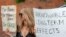 FILE - An anti-vaccine protester holds a sign during a rally outside Houston Methodist Hospital in Houston, Texas, June 26, 2021.