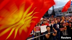 Protesters shout slogans against the change of the country's constitutional name in front of the parliament building in Skopje, Macedonia, June 23, 2018.