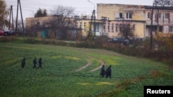 Police officers walk near the site of an explosion in Przewodow, a village in eastern Poland near the border with Ukraine, Nov. 16, 2022. 