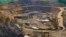 File - Excavators and drillers at work in an open pit at Tenke Fungurume, a copper and cobalt mine 110 kilometers northwest of Lubumbashi in Congo's copper-producing south, owned by miner Freeport McMoRan, Lundin Mining and state mining company Gecamines.