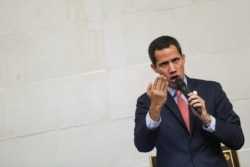 FILE - Venezuelan opposition leader Juan Guaido, who many nations have recognized as the country's rightful interim ruler, gestures as he speaks during an extraordinary session of Venezuela's National Assembly in Caracas, Venezuela, Dec. 17, 2019.