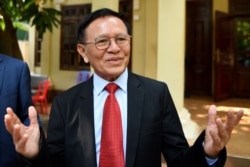 FILE - Kem Sokha, former leader of the now-banned Cambodia National Rescue Party, speaks to reporters as he departs his residence, Jan. 15, 2020.