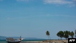 A stranded boat is seen on the coast of Central Sulawesi, Indonesia, Oct. 3, 2018, after an earthquake. A 7.1 magnitude temblor hit nearby North Maluku province Thursday.