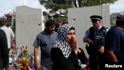 A woman reacts after visiting the reopened Al Noor mosque in Christchurch, New Zealand, March 23, 2019.