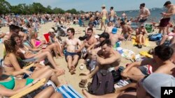 Crowds gather on L Street Beach, Saturday, June 5, 2021, in the South Boston neighborhood of Boston. 
