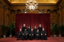 FILE - The justices of the U.S. Supreme Court gather for a formal portrait Nov. 30, 2018. Alabama’s virtual ban on abortion is the latest state law seemingly designed to prod the Supreme Court to reconsider Roe v. Wade.