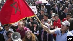 Protesters wave the Moroccan flag in Rabat, Morocco, February 20, 2011