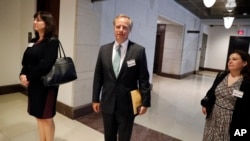 Twitter's Emily Horne, left, global policy communications director; Colin Crowell, center, head of global public policy; and Elizabeth Banker, associate general counsel, wait to enter the closed-door hearing of the House Intelligence Committee on Capitol Hill, Sept. 28, 2017, in Washington.